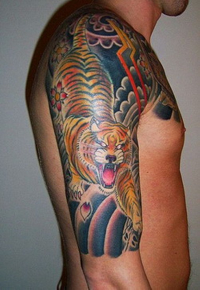 tiger crawling over shoulder tattoo